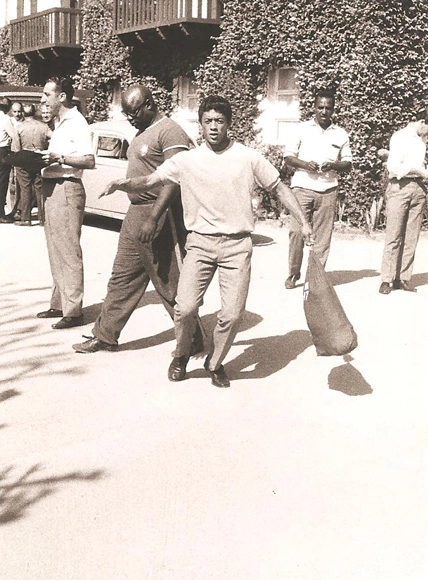 Brincando para ser fotografado, Amarildo carrega sua mochila na chegada à concentração brasileira em Teresópolis, em 1966. Atrás, à esquerda, Pai Santana. Foto: arquivo pessoal de Valdir Joaquim de Moraes