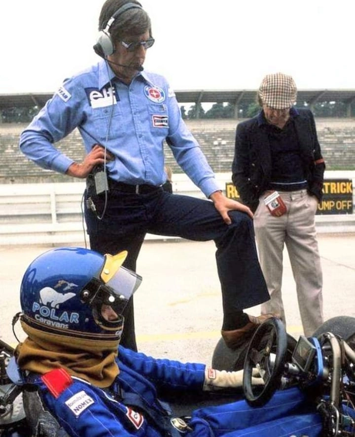 Em pé, com o pé esquerdo sobre uma das seis rodas do Tyrrell P34, Ken Tyrrell observa seu piloto Ronnie Peterson no cockpit durante treino para o GP da Suécia de 1977, em Anderstorp. No capacete, patrocínio da Polar, fabricante sueca de trailers. Foto: Divulgação