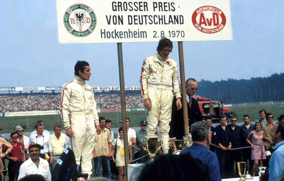 Jochen Ridt, no alto do pódio, em sua última vitória na F1, no GP da Alemanha, disputado em 02 de agosto de 1970, em Hochenheim. À esquerda, o segundo colocado, Jacky Ickx. O terceiro colocado, que não aparece na foto, foi Denny Hulme. Rindt morreu pouco mais de um mês depois, em 05 de setembro. Foto: Reprodução