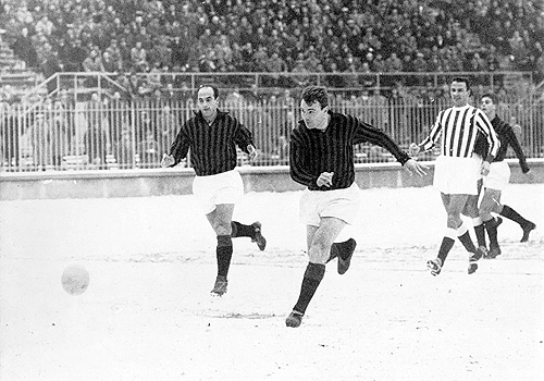 Mazzola e Dino Sani atacam o Lanerossi de Vicenza na neve, em jogo do Campeonato Italiano de 1962. O duelo terminou 6 a 0 para o Milan com três gols de Dino. Observando o desfecho do lance, atrás do jogador do Lanerossi, vemos Rivera