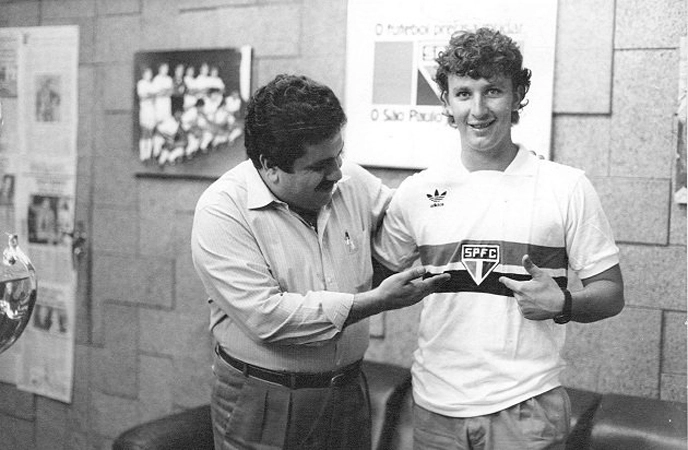 Carlos Miguel, à esquerda, e Neto, apontam para o emblema do São Paulo, orgulhosos por trabalharem na equipe do Morumbi. Foto: Rede Social